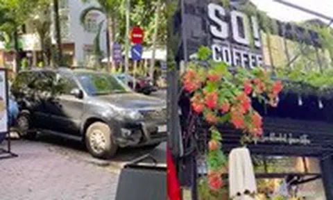 Đỗ xe mua cà phê, bất ngờ bị chủ quán mang xích ra khóa bánh xeicon